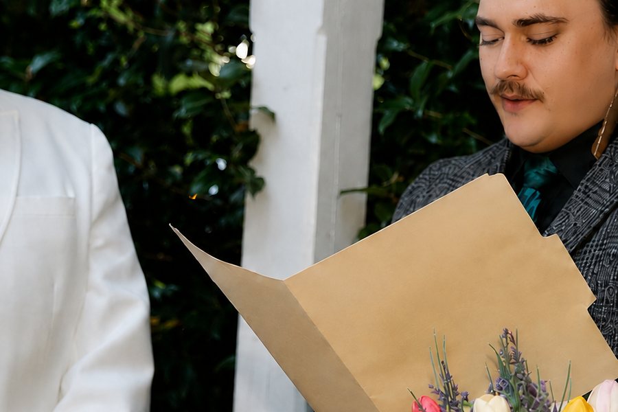 Jacob reading vows during an outdoor ceremony